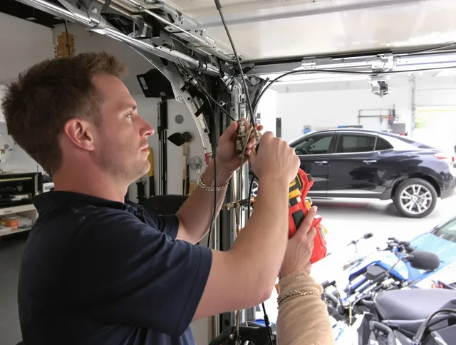 Twinsburg Garage Door Repair safety certified technician performing cable replacement in Twinsburg